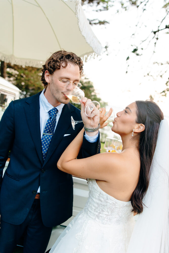 Bride and groom cheers with celebratory champagne