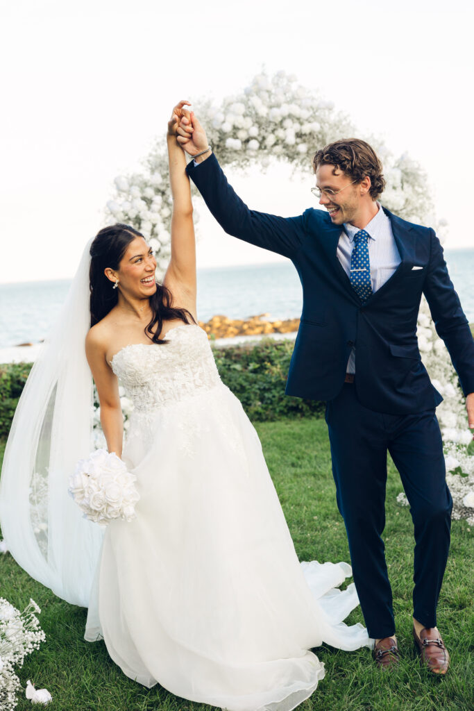 Joyful wedding couple celebrate walking down the aisle after saying I do at Misselwood